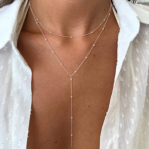Y Necklace worn by model, stacked chains style